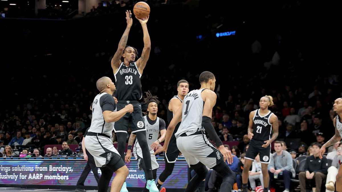 Brooklyn Nets center Nic Claxton (33) takes a shot against San Antonio Spurs forward Keldon Johnson (3) and guard Stephon Castle (5) and forward Victor Wembanyama (1) during the third quarter at Barclays Center.