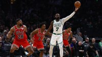 Boston Celtics guard Jaylen Brown (7) gathers in a pass while being double teamed by Chicago Bulls forward Guerschon Yabusele (28) and guard Collin Sexton (2) during the second half at TD Garden.