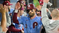 Philadelphia Phillies first baseman Bryce Harper (3) celebrates in the dugout after scoring on a Los Angeles Dodgers throwing error during the fourth inning during game three of the NLDS round for the 2025 MLB playoffs at Dodger Stadium.