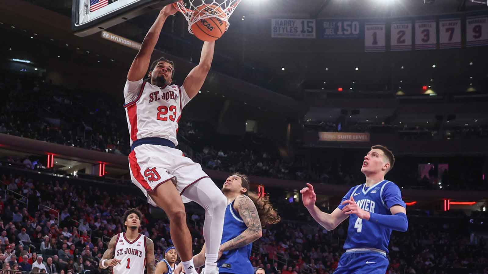St. John's Red Storm forward Bryce Hopkins (23) dunks past Xavier Musketeers forward Filip Borovicanin (4) in the second half at Madison Square Garden.