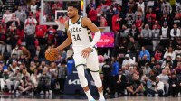 Bucks forward Giannis Antetokounmpo (34) dribbles the ball against the LA Clippers in the second half at Intuit Dome and Clippers' Kawhi Leonard
