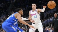 Miami Heat guard Tyler Herro (14) passes the ball away from Milwaukee Bucks forward Giannis Antetokounmpo (34) during the third quarter at Fiserv Forum