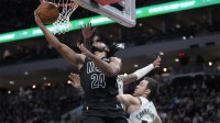 Nets guard Cam Thomas (24) puts up a shot against Milwaukee Bucks guard Pat Connaughton (24) in the second half at Fiserv Forum