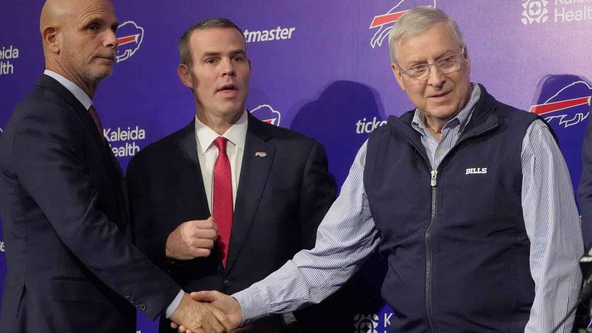 Pete Guelli, president of business operations, Brandon Beane, president of football operations and general manager, shake hands with owner and president Terry Pegula after a group photo with new Bills head coach Joe Brady on Jan. 29, 2026 at the Bills field house.