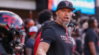 Texas Tech outside linebackers coach C.J. Ah You leads a warmup drill during a Big 12 Conference football game, Saturday, Oct. 11, 2025, at Jones AT&T Stadium in Lubbock.