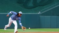 Washington Nationals shortstop CJ Abrams (5) fields a ground ball by Chicago White Sox shortstop Chase Meidroth (not pictured) during the first inning at Nationals Park.