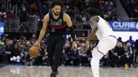 Detroit Pistons guard Cade Cunningham (2) dribbles defended by New York Knicks forward Mohamed Diawara (51) in the second half at Little Caesars Arena.