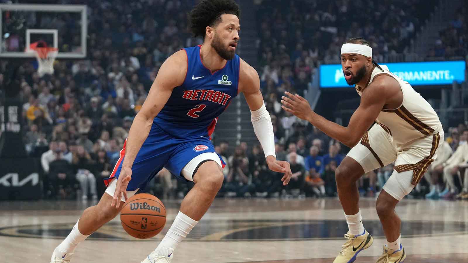 Detroit Pistons guard Cade Cunningham (2) dribbles next to Golden State Warriors guard Moses Moody (4) in the first quarter at the Chase Center.