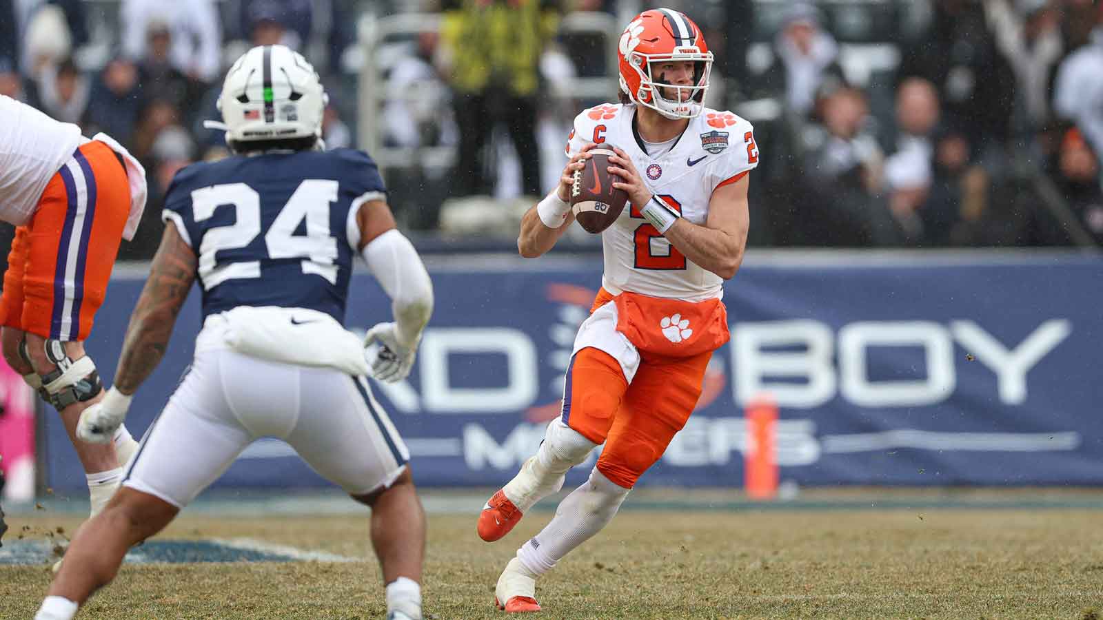 Clemson Tigers quarterback Cade Klubnik (2) scrambles during the first half of the 2025 Pinstripe Bowl in front of Penn State Nittany Lions linebacker Amare Campbell (24) at Yankee Stadium.