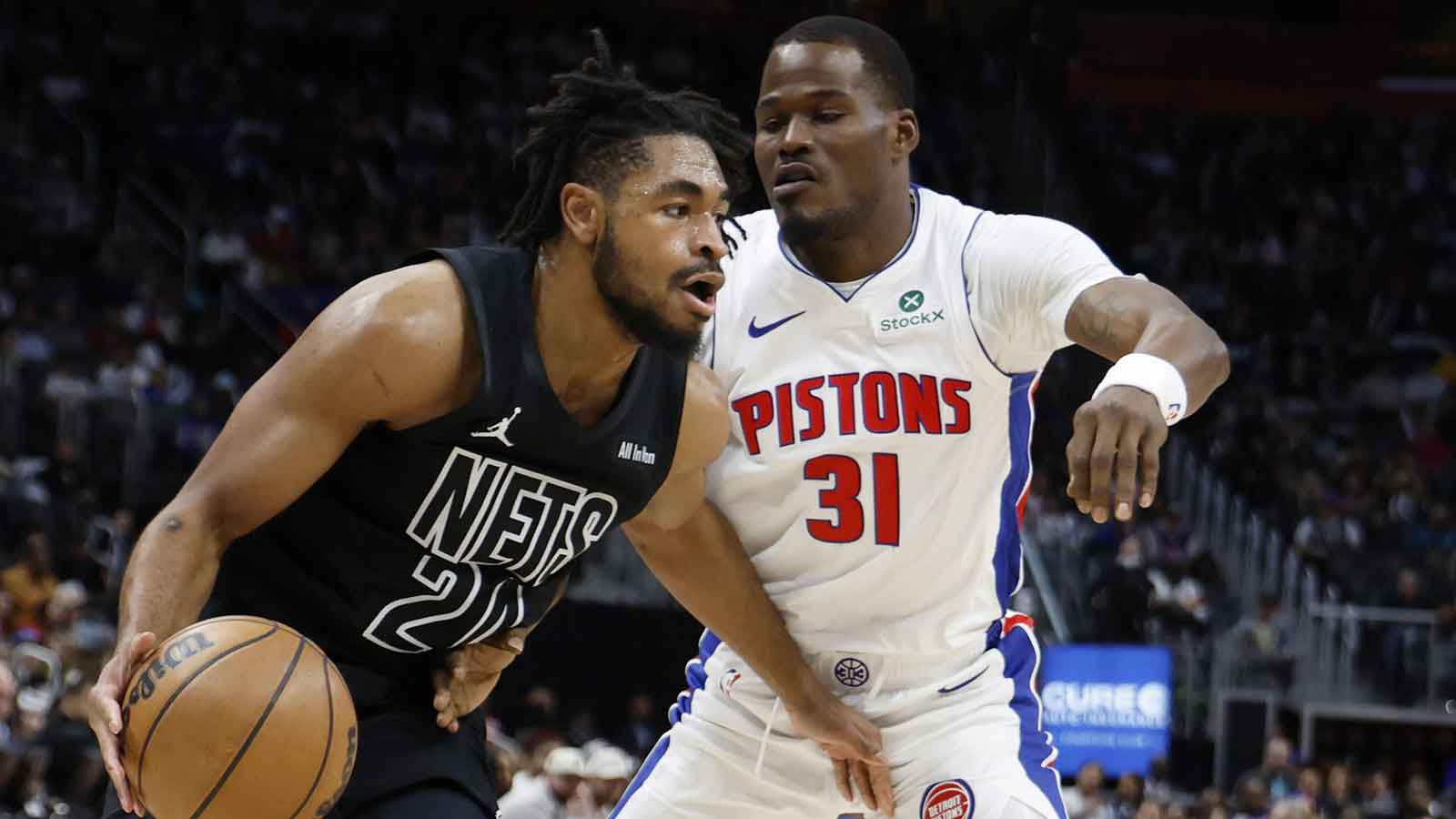 Brooklyn Nets guard Cam Thomas (24) dribbles past Detroit Pistons guard Javonte Green (31) in the first half at Little Caesars Arena. 