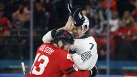 Tom Wilson of Canada clashes with Pierre Crinon of France in men's ice hockey group A play during the Milano Cortina 2026 Olympic Winter Games at Milano Santagiulia Ice Hockey Arena.