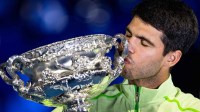 Carlos Alcaraz of Spain with the Norman Brookes Challenge Cup after his victory over Novak Djokovic of Serbia in the final of the menís singles at the Australian Open at Rod Laver Arena in Melbourne Park.