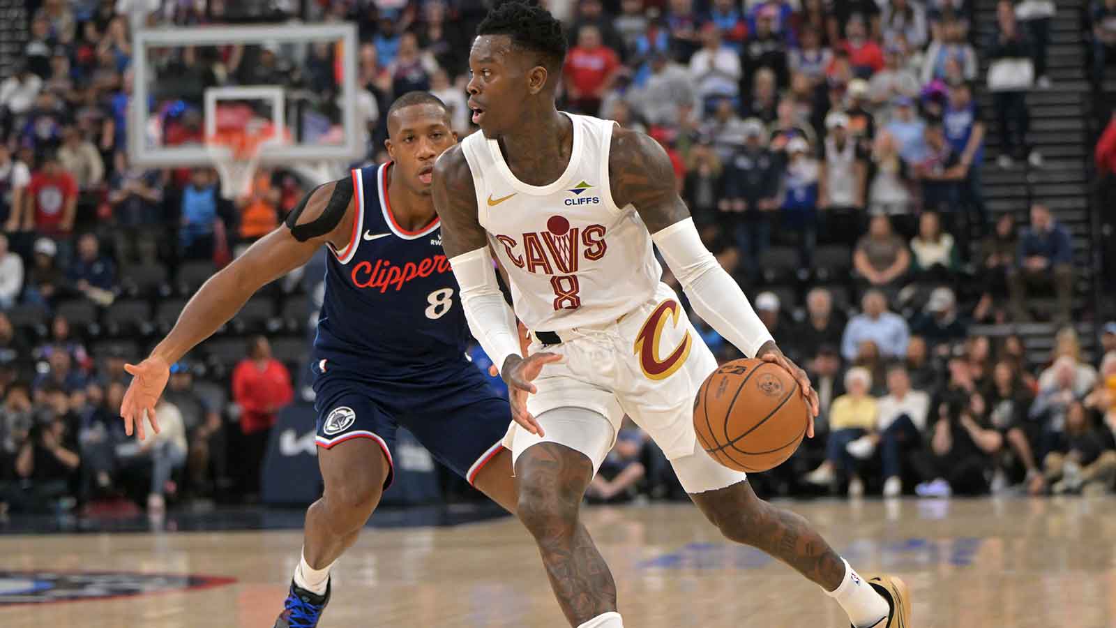 Cleveland Cavaliers guard Dennis Schroder (9) is defended by Los Angeles Clippers guard Kris Dunn (8) as he drives to the basket in the first half at Intuit Dome.
