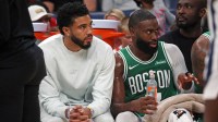Celtics forward Jayson Tatum (0) and guard Jaylen Brown (7) look on from the bench during the second quarter against the Memphis Grizzlies at FedExForum