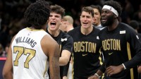 Celtics forward Amari Williams (77) celebrates with teammates after defeating the Brooklyn Nets in double overtime at Barclays Center