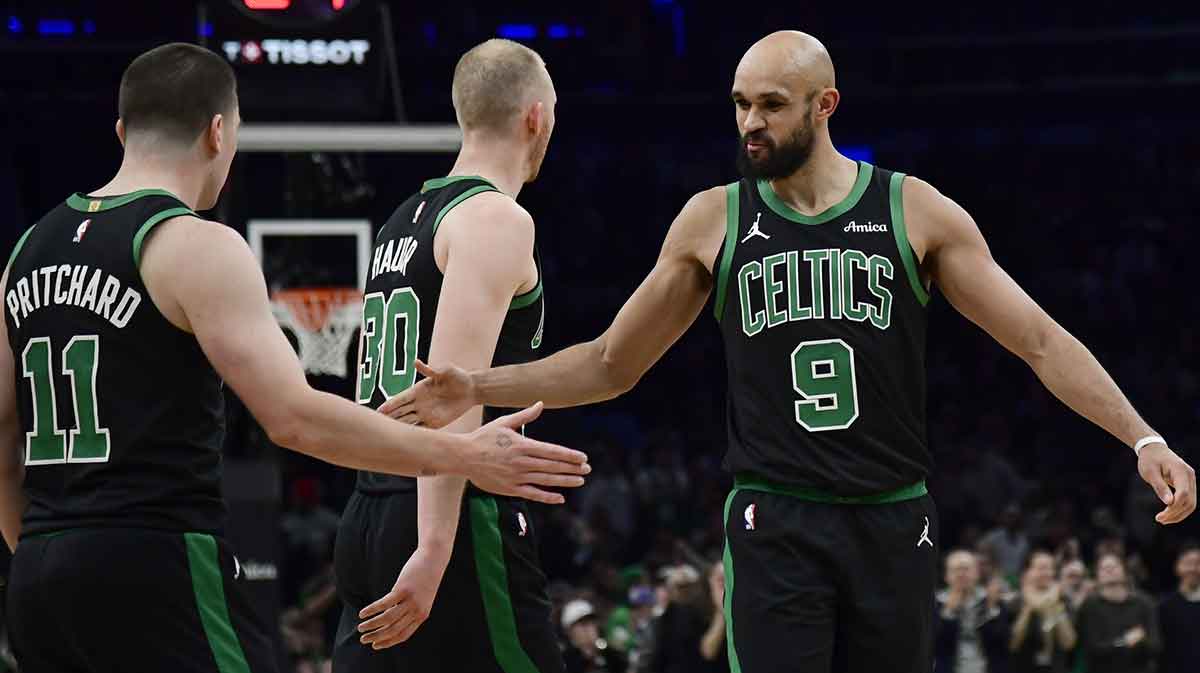 Celtics guard Derrick White (9) congratulates guard Payton Pritchard (11) after making a basket during the second half against the Miami Heat at TD Garden