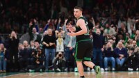 Boston Celtics guard Payton Pritchard (11) reacts after making a three point basket during the second half against the Miami Heat at TD Garden.