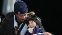 Chloe Kim of the United States with Cleveland Browns player Myles Garrett after her second run in the women's halfpipe final during the Milano Cortina 2026 Olympic Winter Games at Livigno Snow Park.