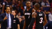 Miami Heat head coach Erik Spoelstra with center Chris Bosh (1) and guard Dwyane Wade (3) against the Phoenix Suns at Talking Stick Resort Arena. The Heat defeated the Suns 103-95.