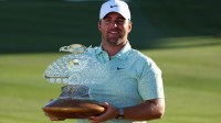 Chris Gotterup of the United States celebrates his win with the trophy after the final round of the WM Phoenix Open golf tournament.