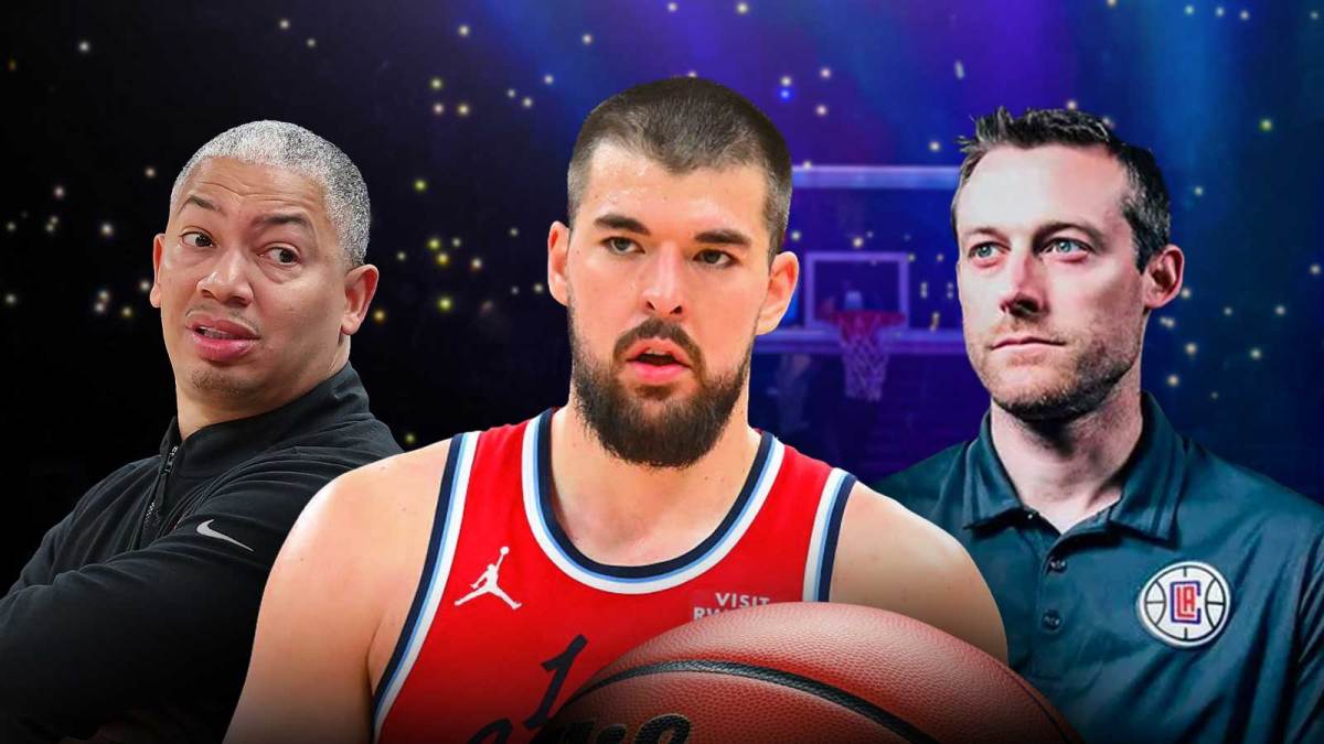 Ivica Zubac in the middle, Coach Tyronn Lue and GM Trent Redden around him, Los Angeles Clippers wallpaper in the background