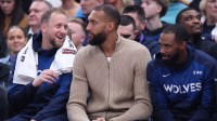 Three former Utah Jazz players sit on the Minnesota Timberwolves bench from left to right guard Joe Ingles, center Rudy Gobert and guard Mike Conley during the second quarter at Delta Center