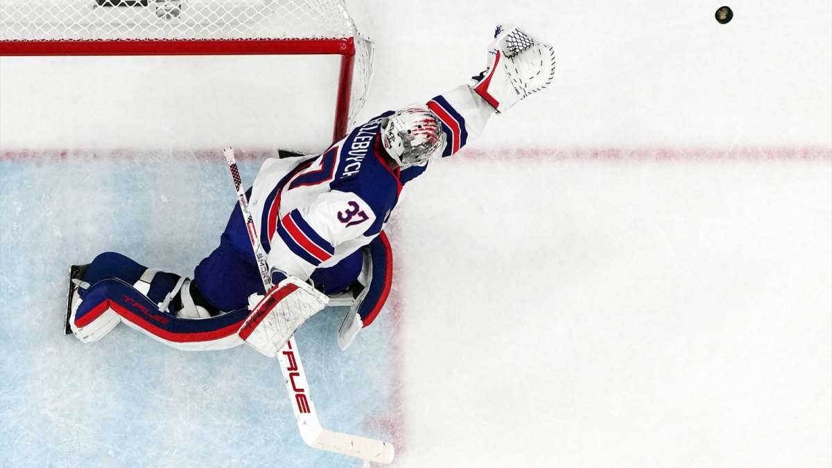 Connor Hellebuyck of United States makes a save during the men's ice hockey gold medal game during the Milano Cortina 2026 Olympic Winter Games at Milano Santagiulia Ice Hockey Arena