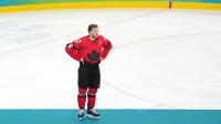 ; Matthew Tkachuk of the United States and Connor McDavid of Canada reacts after the men's ice hockey gold medal game during the Milano Cortina 2026 Olympic Winter Games at Milano Santagiulia Ice Hockey Arena.
