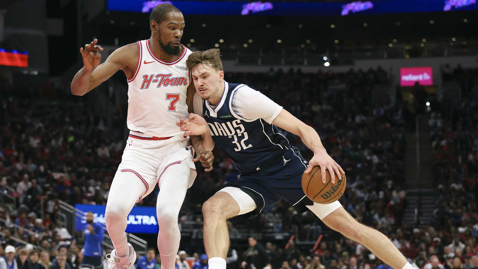 Dallas Mavericks forward Cooper Flagg (32) drives with the ball as Houston Rockets forward Kevin Durant (7) defends during the third quarter at Toyota Center.
