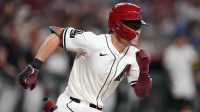 Arizona Diamondbacks batter Corbin Carroll (7) takes off for first base after hitting a double against the Los Angeles Dodgers at Chase Field in Phoenix.
