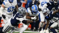 Detroit Lions running back Jahmyr Gibbs (0) is tackled by Dallas Cowboys defensive tackle Quinnen Williams (92) during the first half at Ford Field.