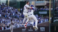 Chicago Cubs catcher Carson Kelly (15) celebrates his game winning single with outfielder Pete Crow-Armstrong (4) against the Atlanta Braves during the tenth inning at Wrigley Field.