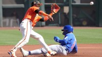 Chicago Cubs third baseman Matt Shaw (6) slides under the tag by San Francisco Giants shortstop Willy Adames (2) in the first inning at Scottsdale Stadium.