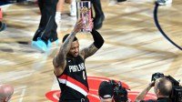 Portland Trail Blazers guard Damian Lillard (0) celebrates with the trophy after winning the three point contest during the 2026 NBA All Star Saturday Night at Intuit Dome.