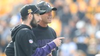 Baltimore Ravens assistant quarterbacks coach Daniel Stern (left) talks with head coach John Harbaugh (right) during warm ups against the Pittsburgh Steelers at Acrisure Stadium.