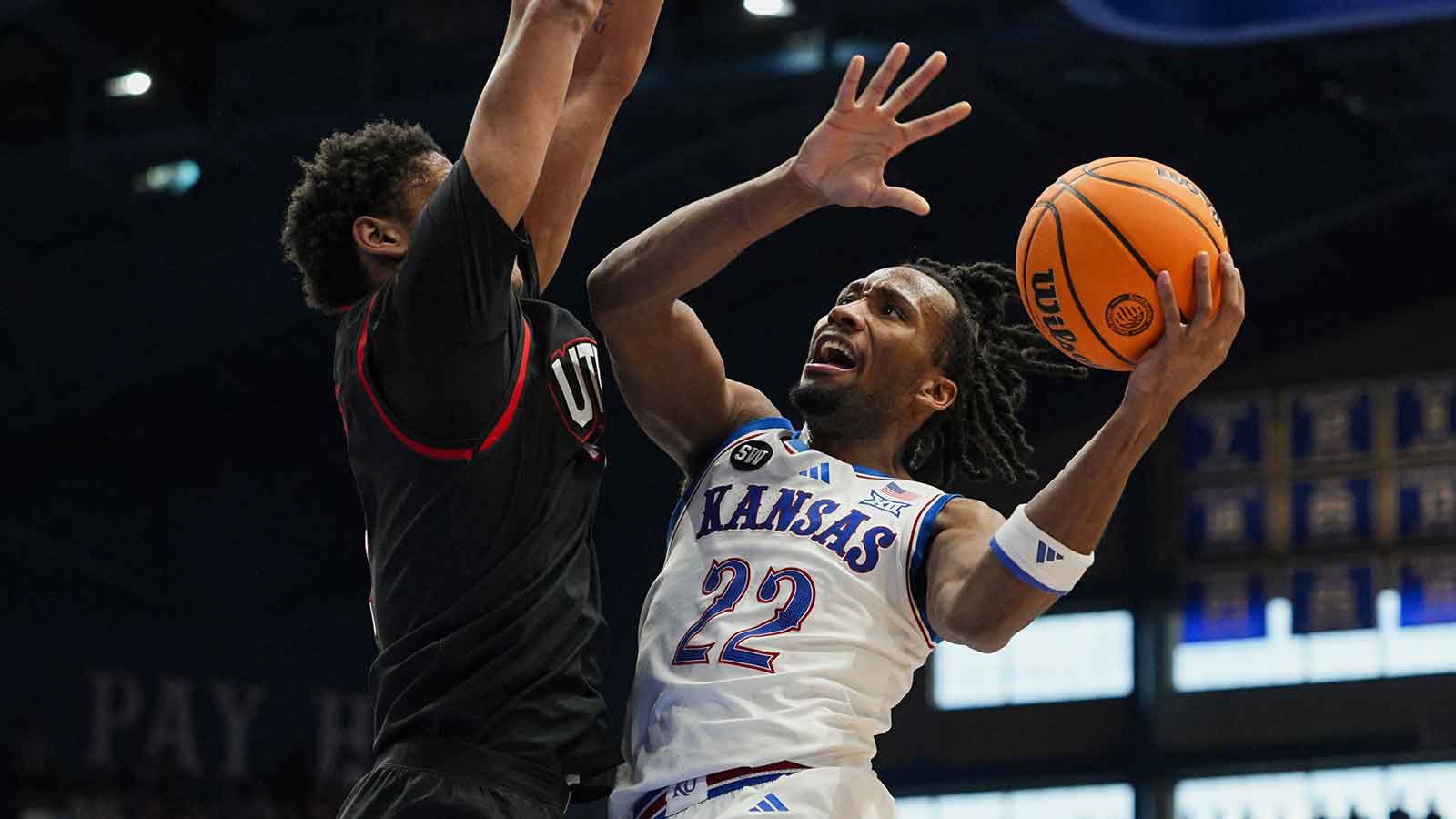 Kansas Jayhawks guard Darryn Peterson (22) shoots against Utah Utes forward Josh Hayes (7) during the second half at Allen Fieldhouse.