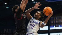 Kansas Jayhawks guard Darryn Peterson (22) shoots against Utah Utes forward Josh Hayes (7) during the second half at Allen Fieldhouse.