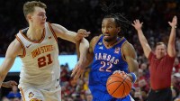 Kansas Jayhawks guard Darryn Peterson (22) drives with the ball as Iowa State Cyclones forward Dominykas Pleta (21) during the second half in the Big-12 conference basketball showdown on Feb. 14, 2026, at Hilton Coliseum, in Ames, Iowa.