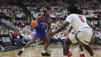 Kansas Jayhawks guard Darryn Peterson (22) dribbles the ball against Texas Tech Red Raiders guard Jazz Henderson (2) in the second half at United Supermarkets Arena.