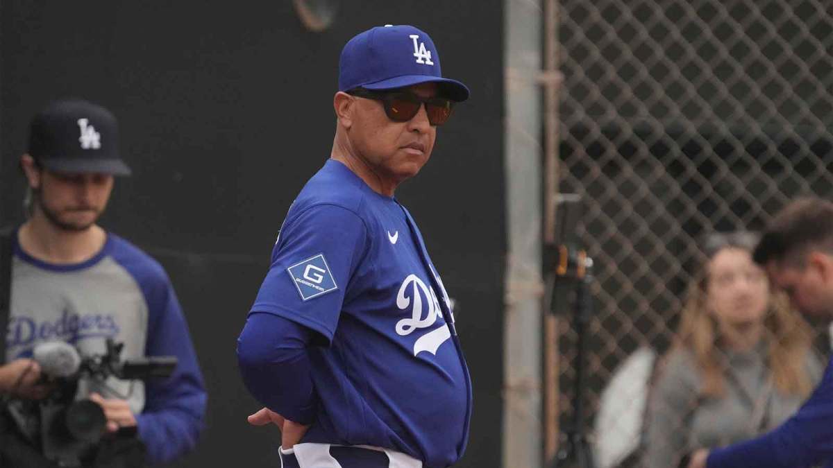 Los Angeles Dodgers manager Dave Roberts (30) watches from the bullpen during spring training camp.