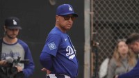 Los Angeles Dodgers manager Dave Roberts (30) watches from the bullpen during spring training camp.