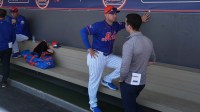 New York Mets president of baseball operations, David Stearns, right, speaks with manager Carlos Mendoza during workouts at spring training.