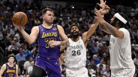 Los Angeles Lakers guard Luka Doncic (77) passes the ball by Dallas Mavericks guard Spencer Dinwiddie (26) and forward Anthony Davis (3) during the third quarter at the American Airlines Center