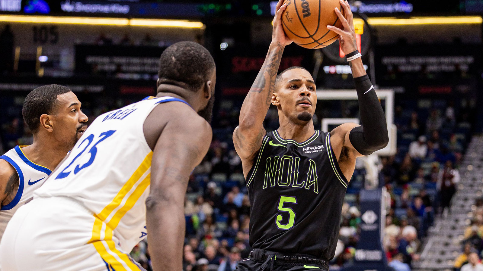 New Orleans Pelicans guard Dejounte Murray (5) dribbles against Golden State Warriors forward Draymond Green (23) during the first half at Smoothie King Center.