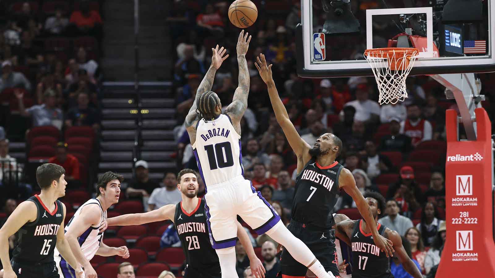 Houston Rockets forward Kevin Durant (7) defends as Sacramento Kings guard DeMar DeRozan (10) shoots the ball during the first quarter at Toyota Center.