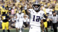Washington Huskies wide receiver Denzel Boston (12) celebrates after he makes a reception in the first half against the Michigan Wolverines at Michigan Stadium.