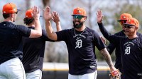Detroit Tigers second baseman Gleyber Torres high-fives teammates after practicing a drill during spring training at TigerTown.