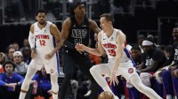Detroit Pistons forward Duncan Robinson (55) dribbles defended by Brooklyn Nets guard Terance Mann (14) in the first half at Little Caesars Arena.