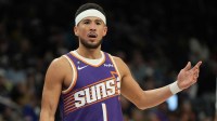 Phoenix Suns guard Devin Booker (1) reacts after a foul call against the Philadelphia 76ers during the second half of an NBA game at Mortgage Matchup Center.