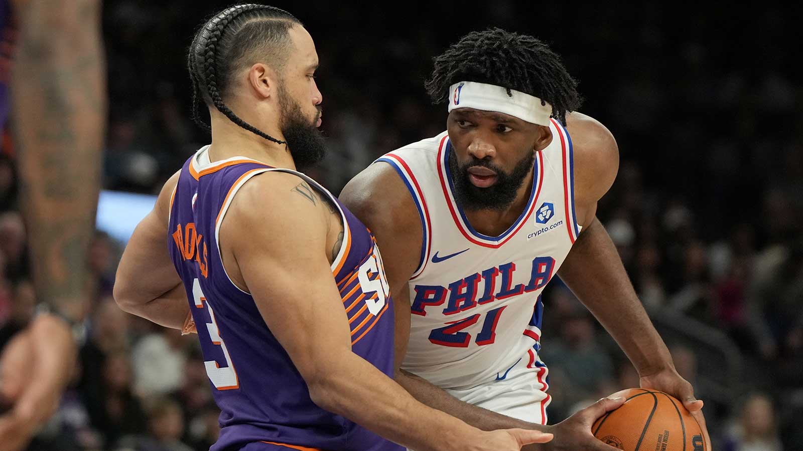 Philadelphia 76ers center Joel Embiid (21) shields the ball from Phoenix Suns forward Dillon Brooks (3) during the second half of an NBA game at Mortgage Matchup Center. 